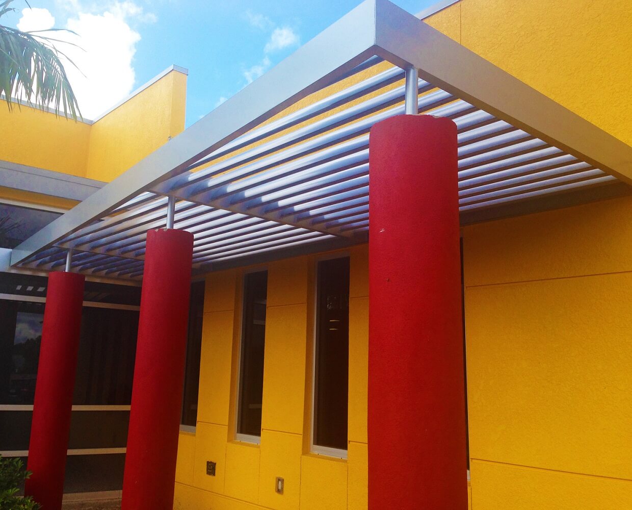 aluminum sunshades supported by red pillars